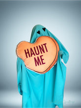 Load image into Gallery viewer, a 22 inch pillow, shaped like a candy heart that says &quot;Haunt Me&quot; 