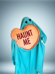 a 22 inch pillow, shaped like a candy heart that says "Haunt Me" 